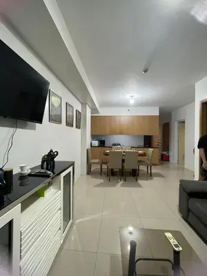 a living room with a couch and a dining room at Shell Residence in Manila