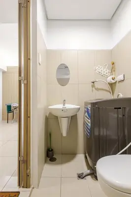 a bathroom with a sink and a toilet at Sunrise & City View Steps from MOA & Bay Free WiFi in Manila