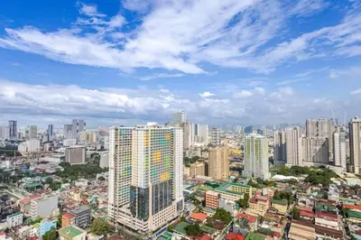 a view of a city with tall buildings at Sunrise & City View Steps from MOA & Bay Free WiFi in Manila