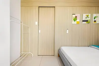 a bedroom with a bed and a glass door at Sunrise & City View Steps from MOA & Bay Free WiFi in Manila