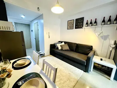 a living room with a couch and a table at CL10100 House in Manila