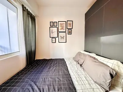 a bedroom with a bed and a window at CL10100 House in Manila
