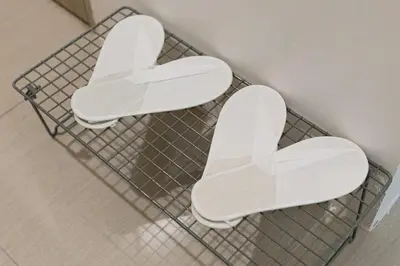 two white toilet seats on a wire rack at CB 1162 House in Manila