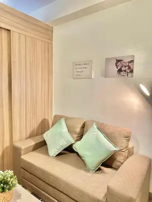 a living room with a couch with two pillows at CB 1162 House in Manila