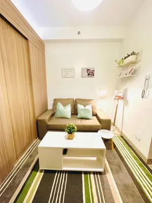 a small living room with a couch and a table at CB 1162 House in Manila