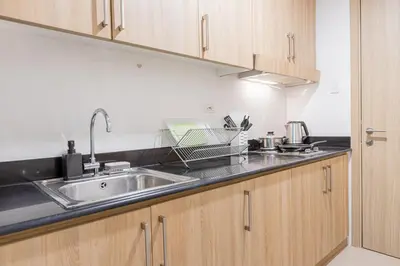 a kitchen with a sink and wooden cabinets at CB 1162 House in Manila