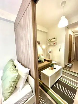 a small room with a bed and a table at CB 1162 House in Manila