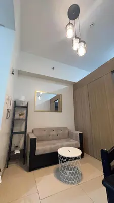 a living room with a couch and a table at Yuttari in Manila