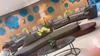 a woman sitting in a waiting room with a couch at Yuttari in Manila