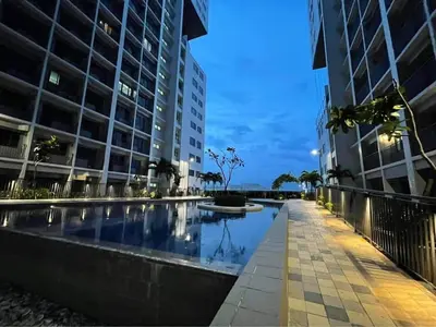 a swimming pool in a city with tall buildings at Yuttari in Manila