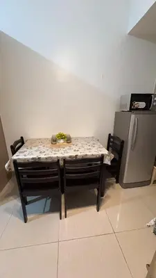 a table in a kitchen next to a refrigerator at Yuttari in Manila