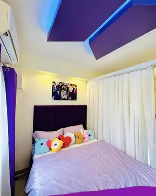 a bedroom with a purple bed with stuffed animals on it at BTS CRIB at MOA PASAY CITY in Manila