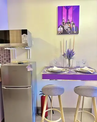 a kitchen with a counter with two stools and a counter top at BTS CRIB at MOA PASAY CITY in Manila