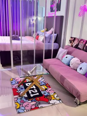 a room with two beds and a glass table at BTS CRIB at MOA PASAY CITY in Manila