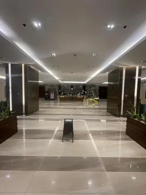a lobby with a bench in the middle of a building at JCS Place in Manila