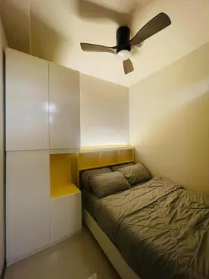 a bedroom with a bed and a ceiling fan at JCS Place in Manila