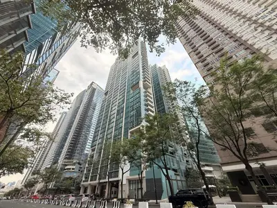a tall building with many windows in a city at BGC One Uptown in Manila