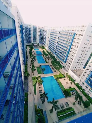 an aerial view of a pool in front of a building at Sea Residences Mall of Asia- Jerson in Manila