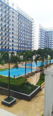 a view of a large apartment building with a pool at Sea Residences Mall of Asia- Jerson in Manila