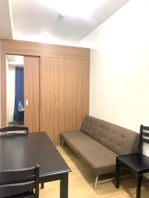 a living room with a couch and a table at Ohana Residences by SMDC in Manila