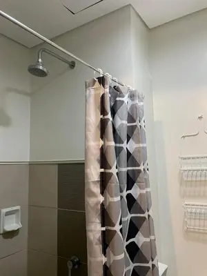 a shower with a shower curtain in a bathroom at Ohana Residences by SMDC in Manila