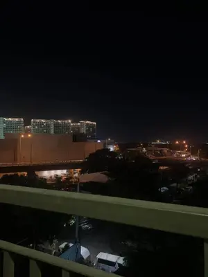 a view of a city at night with lights at Ohana Residences by SMDC in Manila