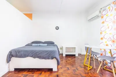 a bedroom with a bed and a table and chairs at Stylish Hip studio in the Heart of Poblacion, in Manila