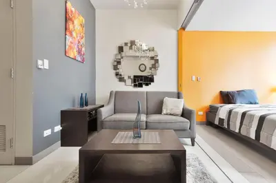a living room with a couch and a bed at Stylish condo in BGC near Uptown mall and St Lukes in Manila