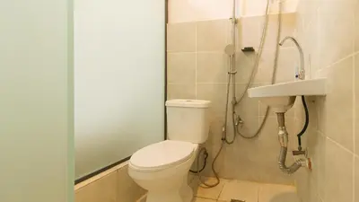 a bathroom with a toilet and a sink at GREN PLACE near Baclaran Airport Road by RedDoorz in Manila