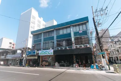a building on the corner of a city street at GREN PLACE near Baclaran Airport Road by RedDoorz in Manila