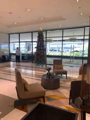 a christmas tree in the middle of a lobby at 81 Newport Blvd Cluster 5 Unit 3F by Rechelle Nunag in Manila