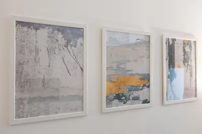 three pieces of art hanging on a wall at BD281 House in Manila
