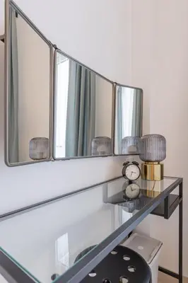 a mirror on a shelf with a clock on it at BD281 House in Manila