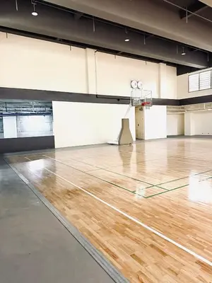 an empty gymnasium with a wooden basketball court at JFam Suites Allegra Condo with Balcony, FREE Parking in Manila