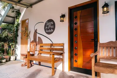 a room with a wooden bench and a door at Sotera and Paz Forestville in Silang