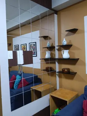 a room with a mirror with shelves on the wall at Shore residences tower D by Ben in Manila