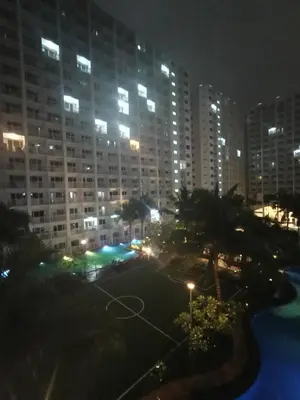 a view of a city at night with tall buildings at Shore residences tower D by Ben in Manila