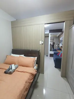 a bedroom with a large bed with orange pillows at Shore residences tower D by Ben in Manila