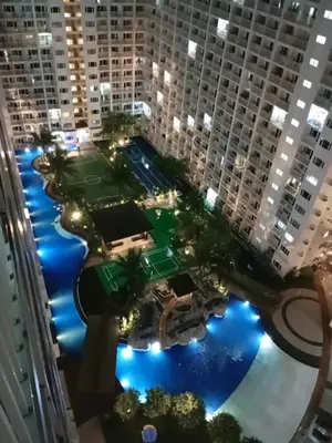 an aerial view of a tennis court in a city at night at Shore residences tower D by Ben in Manila