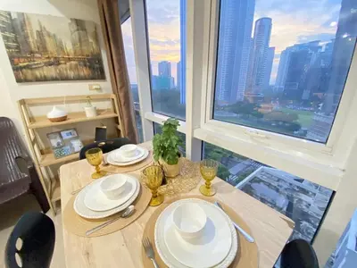a table in a room with a view of a city at South of Market Private Residences nr SM Aura BGC in Manila