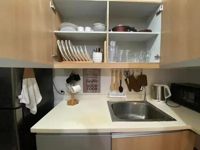 a kitchen with a sink and a counter top at South of Market Private Residences nr SM Aura BGC in Manila