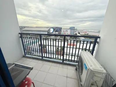 a balcony with a bench and a view of a city at Sea Residences MoaPasay City By Jerson in Manila