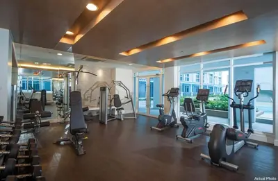 a gym with treadmills and exercise equipment in a building at The Linear Makati Free Wifi & Netflix LM1 in Manila