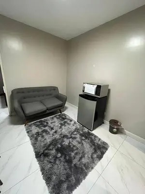 a living room with a couch and a rug at Monarch parksuites 1bedroom with free pool access in Manila