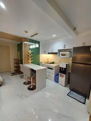 a kitchen with a counter and a refrigerator at 1 BR Nordic Suite with Netflix, Disney, Prime in Manila