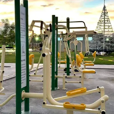 a playground with white and yellow equipment in a park at 1 BR Nordic Suite with Netflix, Disney, Prime in Manila