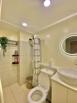 a bathroom with a toilet and a sink at The Cozy Cove - 3BR with Netflix, Prime and KTV in Manila