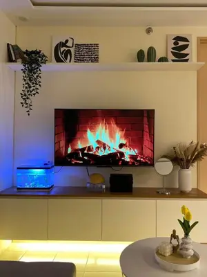 a living room with a fire place in a fireplace at The Cozy Cove - 3BR with Netflix, Prime and KTV in Manila