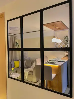 a view of a living room through a window at The Cozy Cove - 3BR with Netflix, Prime and KTV in Manila