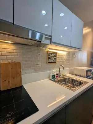 a kitchen with a sink and a counter top at d'DEN at SMDC AIR Makati 1BR Bay view in Manila